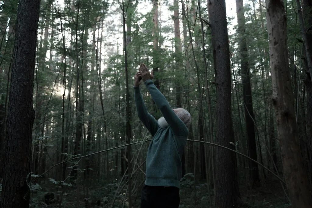 A man searching for signal in the woods